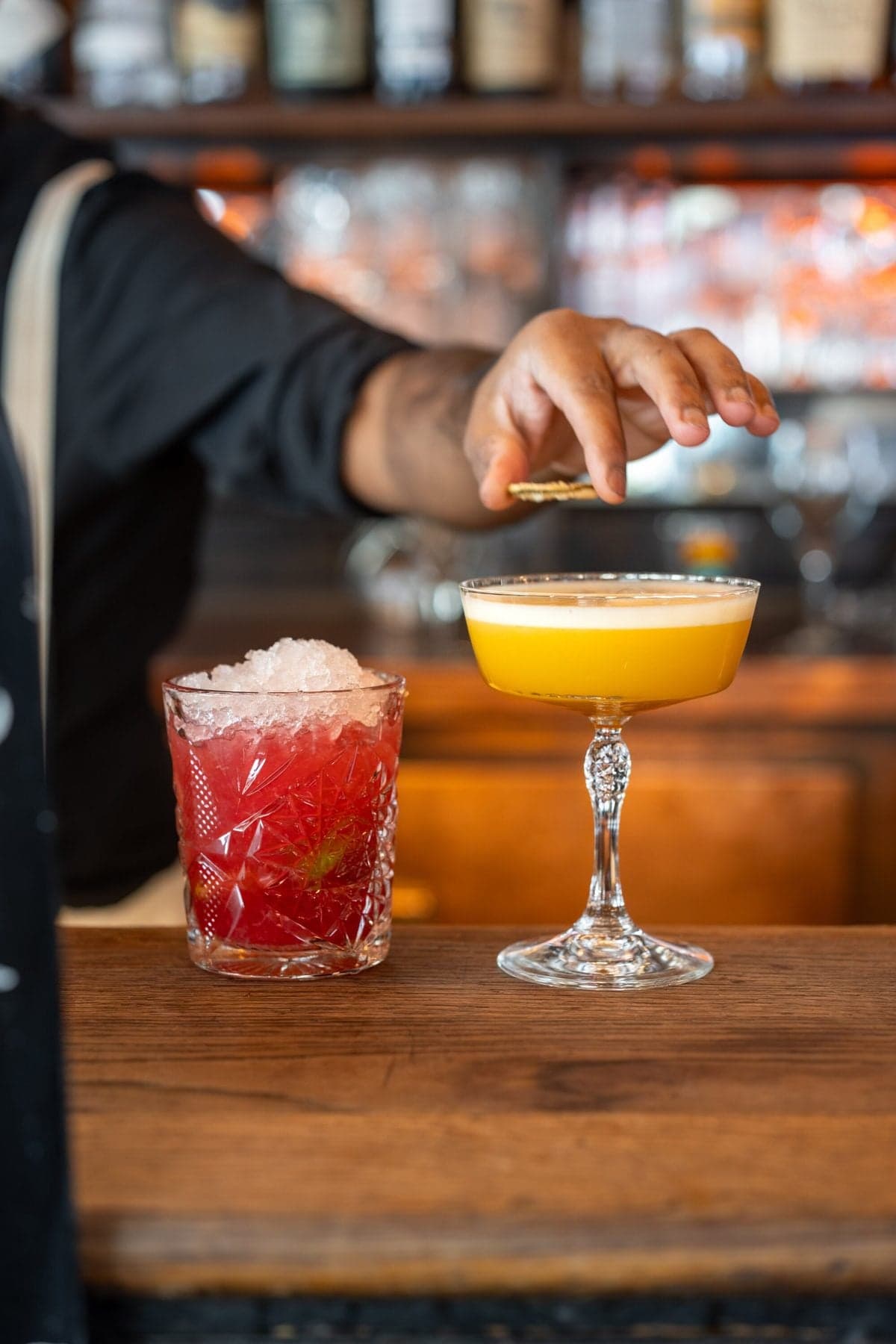Le barman termine un cocktail au comptoir